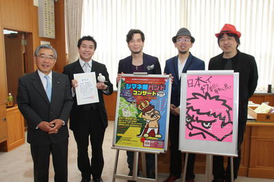 訪問された皆さんと一緒に記念撮影に臨む知事