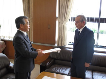 目録を受け取る知事